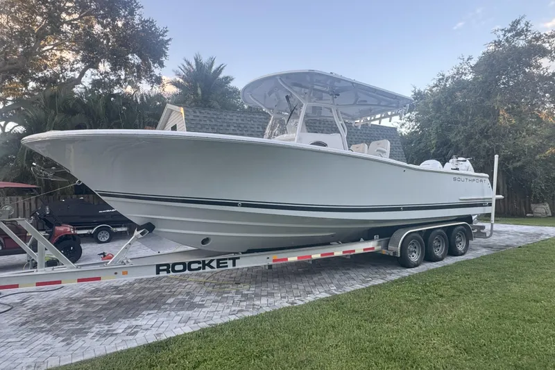 Slide: The Image of 2023 Southport 30 FE boat on a trailer, parked in a driveway. - 7