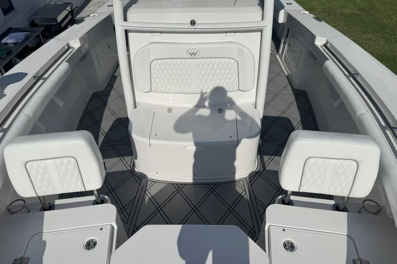 Slide: The Image of 2023 Southport 30 FE boat interior with white seating and diamond-patterned flooring. - 9
