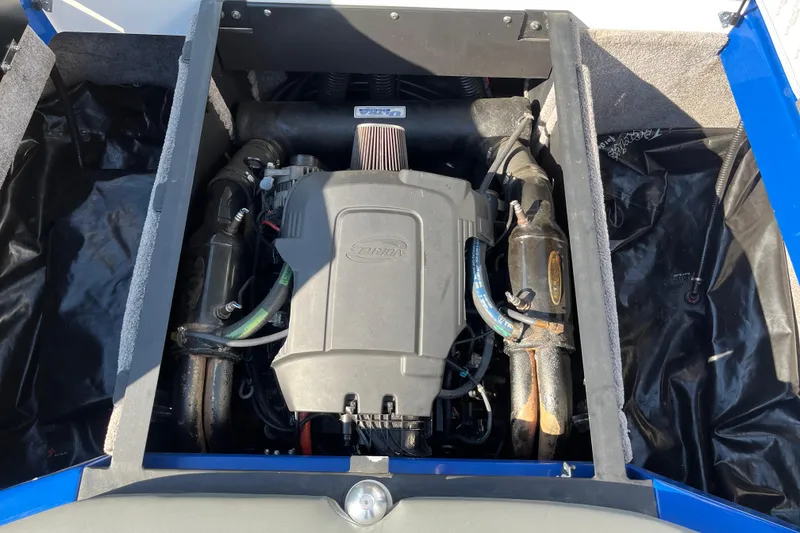 Slide: The Image of Engine compartment of a 2012 Supra Launch 242 boat, showcasing the motor and components. - 14