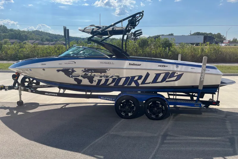 Slide: The Image of 2012 Supra Launch 242 boat on trailer, featuring bold graphics and sleek design. - 5