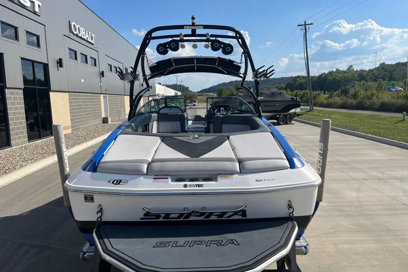 Slide: The Image of 2012 Supra Launch 242 boat parked outside a dealership on a sunny day. - 8