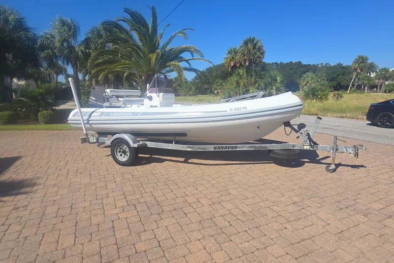 Slide: The Image of Novurania DL 550 boat on clear turquoise water, 2011 model, under sunny skies. - 1