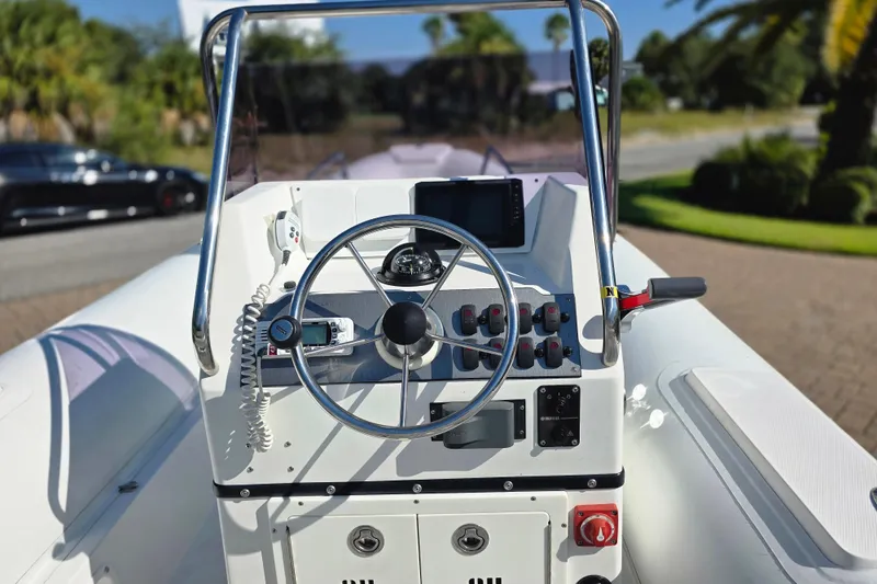 Slide: The Image of 2011 Novurania DL 550 boat interior with white seating and stainless steel railings. - 5