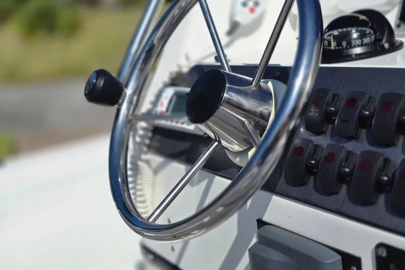 Slide: The Image of 2011 Novurania DL 550 boat, close-up view, surrounded by lush greenery and palm trees. - 6