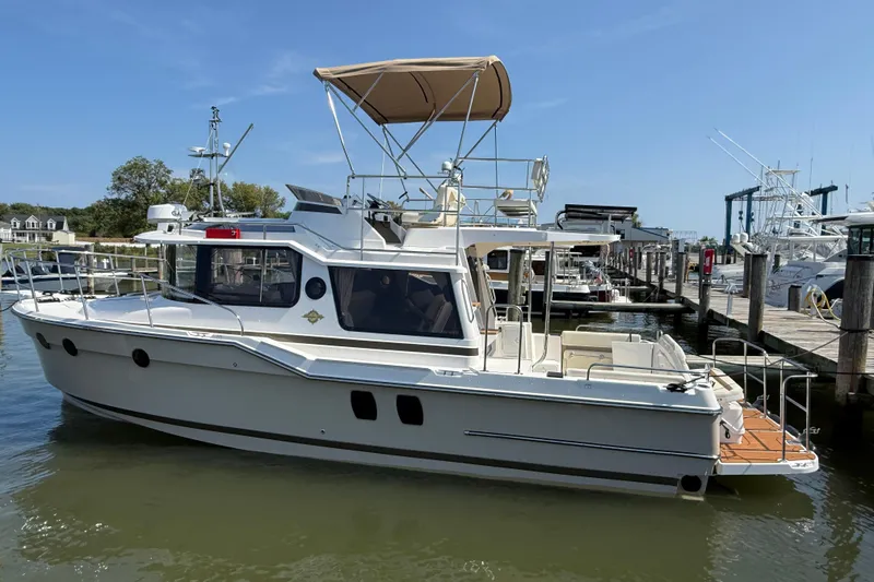 Slide: The Image of 2026 Ranger Tugs R-29 CB docked at marina, featuring upper deck and modern design. - 1