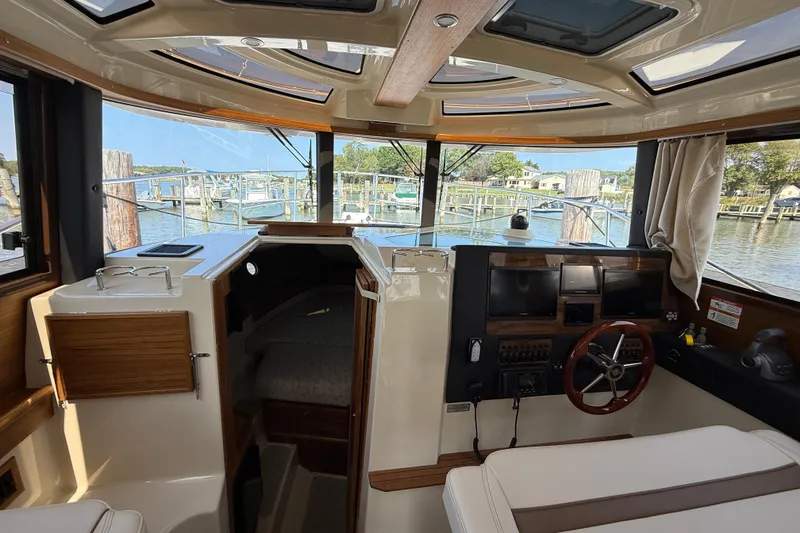 Slide: The Image of Interior view of 2026 Ranger Tugs R-29 CB boat with helm and cabin area. - 10