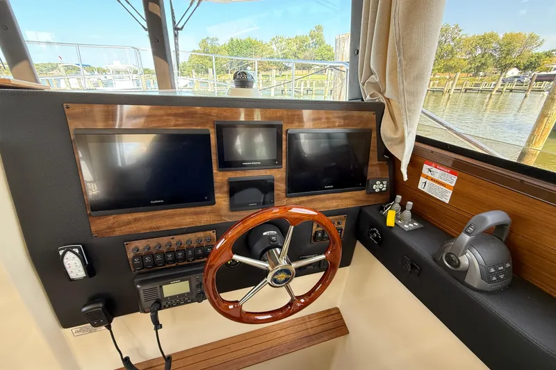 Slide: The Image of Helm of 2026 Ranger Tugs R-29 CB with modern navigation displays and controls. - 11