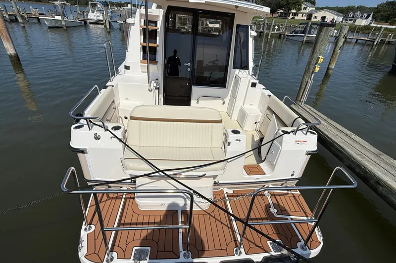 Slide: The Image of 2026 Ranger Tugs R-29 CB boat docked, featuring spacious deck and seating area. - 2