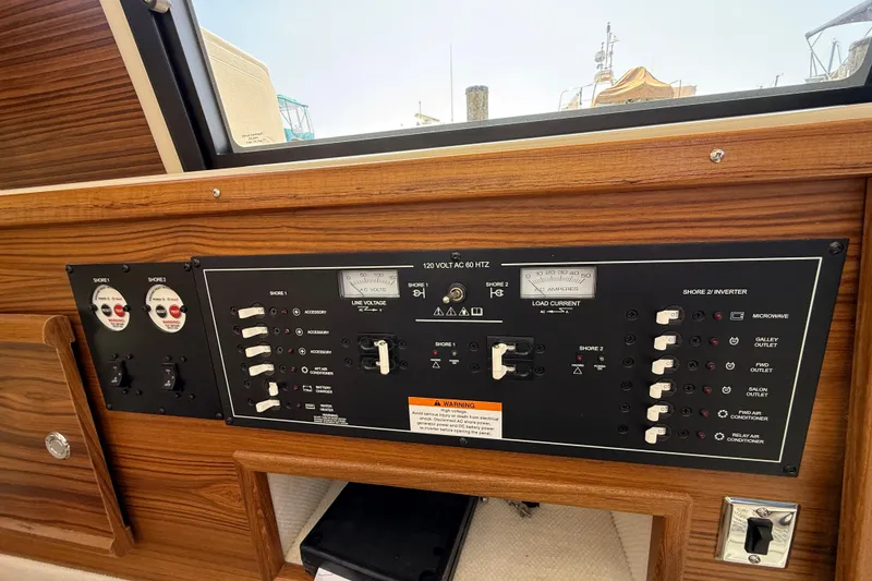 Slide: The Image of Electrical control panel on 2026 Ranger Tugs R-29 CB boat, featuring switches and gauges. - 23