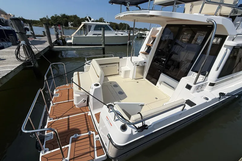 Slide: The Image of 2026 Ranger Tugs R-29 CB boat docked, featuring spacious deck and seating area. - 3