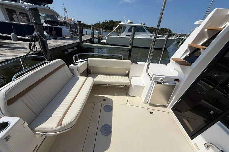 Slide: The Image of 2026 Ranger Tugs R-29 CB boat deck with seating, docked at marina. - 4