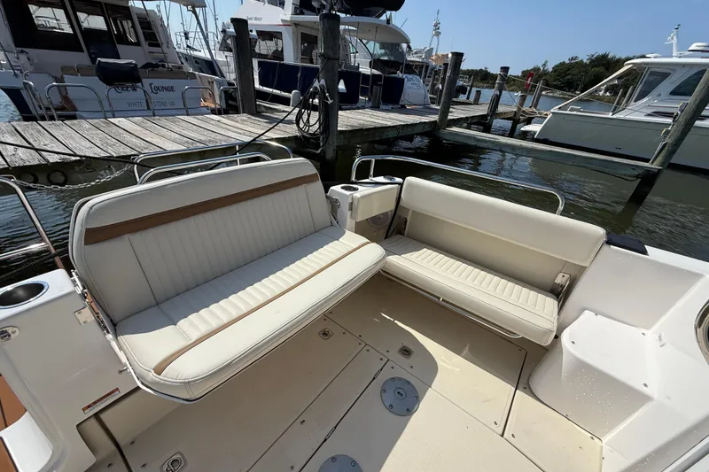 Slide: The Image of 2026 Ranger Tugs R-29 CB boat interior with beige seating at marina. - 5