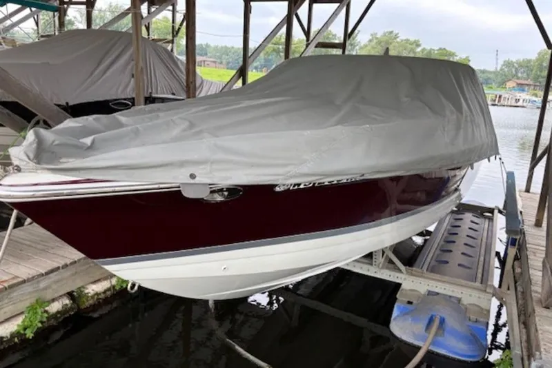 The Image of 2007 Formula 260 Sun Sport boat covered and docked in a marina. - 1