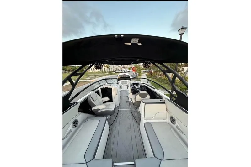 Slide: The Image of 2022 Yamaha Boats 252XE rear view with logo and seating, under a clear blue sky. - 11