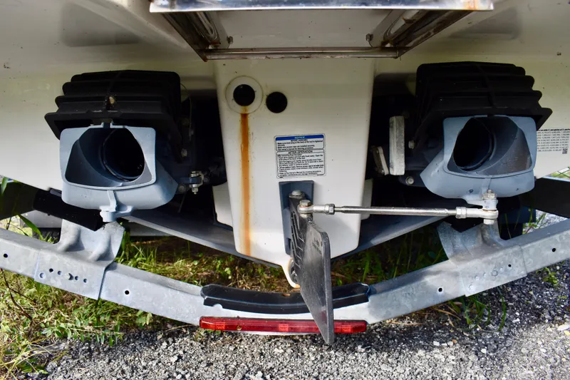 Slide: The Image of 2022 Yamaha Boats 252XE on trailer, parked outdoors on gravel. - 16