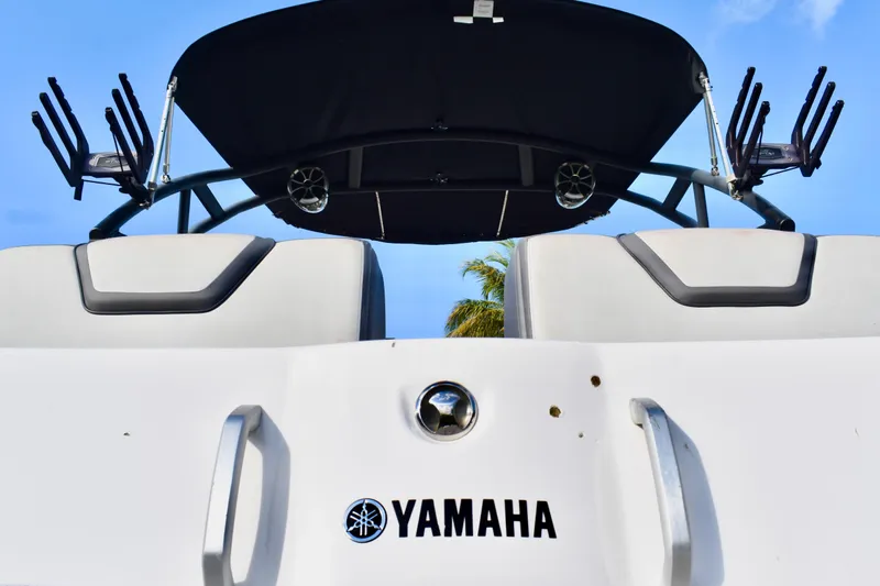 Slide: The Image of Storage compartment in 2022 Yamaha Boats 252XE with life jacket and water jug. - 22