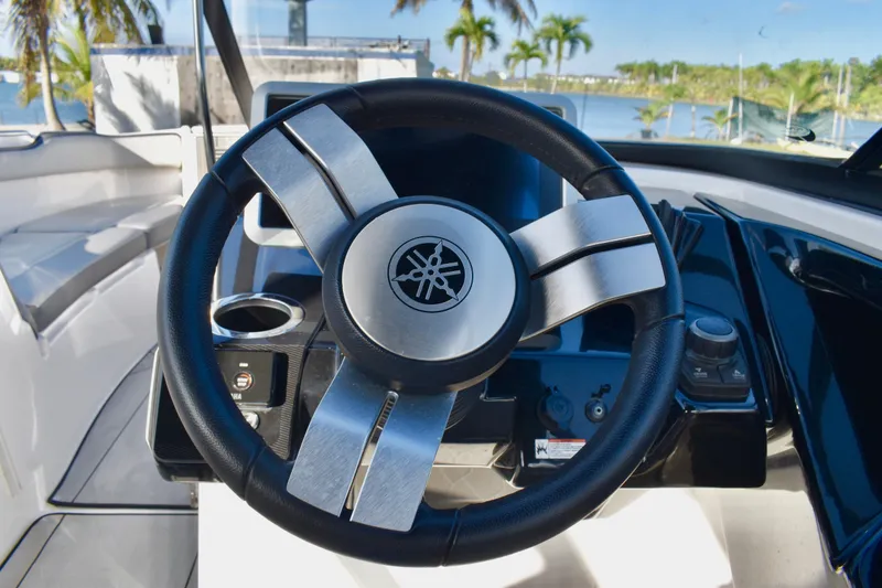 Slide: The Image of Steering wheel of 2022 Yamaha Boats 252XE, with sleek design and modern controls. - 26