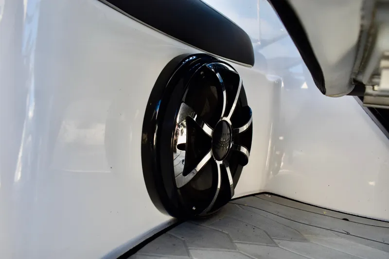 Slide: The Image of 2022 Yamaha Boats 252XE speaker detail on sleek white interior. - 29