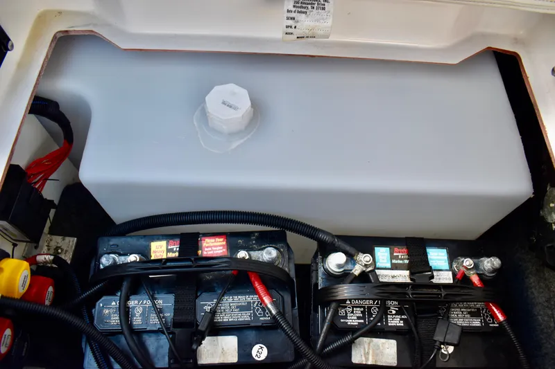 Slide: The Image of 2022 Yamaha Boats 252XE battery compartment with dual batteries and wiring. - 34