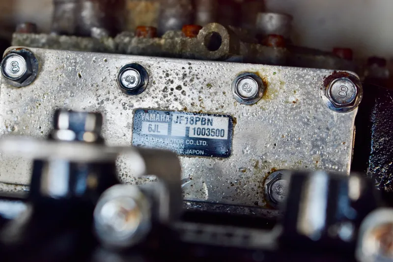 Slide: The Image of Close-up of a Yamaha 252XE 2022 engine part with visible serial number and bolts. - 42