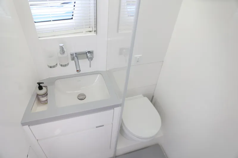 Slide: The Image of Modern bathroom in 2023 Limitless Seas XLV yacht with sink and toilet. - 11