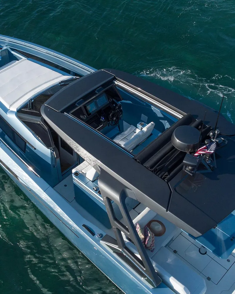 Slide: The Image of 2023 Limitless Seas XLV luxury boat cruising on clear blue water. - 13