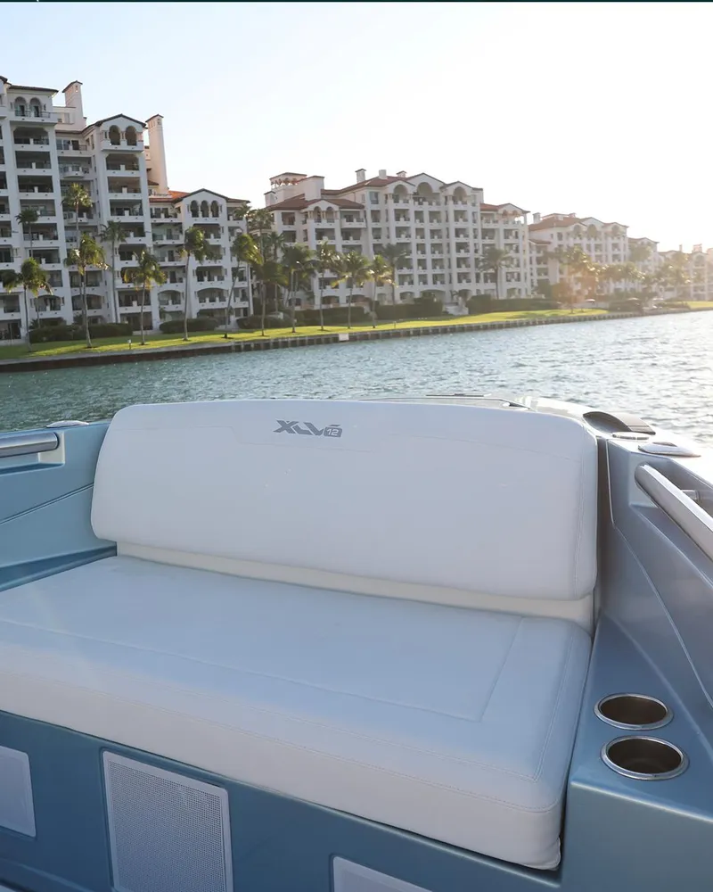 Slide: The Image of Luxury Limitless Seas XLV 2023 boat with waterfront view of upscale apartments. - 17