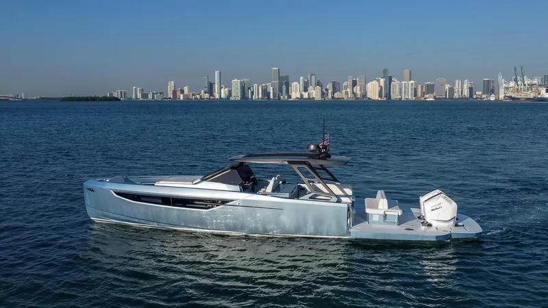 Slide: The Image of 2023 Limitless Seas XLV luxury yacht cruising near a city skyline. - 2
