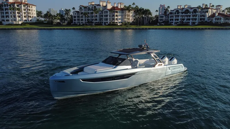 Slide: The Image of 2023 Limitless Seas XLV luxury yacht cruising near waterfront residences. - 3