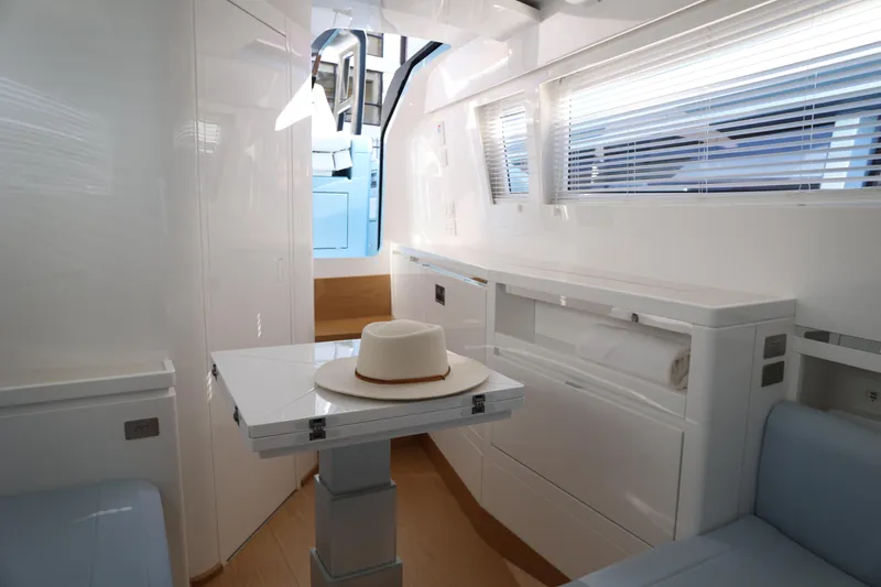 Slide: The Image of Modern interior of 2023 Limitless Seas XLV yacht with sleek design and hat on table. - 9