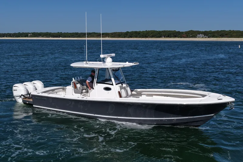 Slide: The Image of 2024 Regulator 34 boat cruising on open water, featuring sleek design and powerful engines. - 10