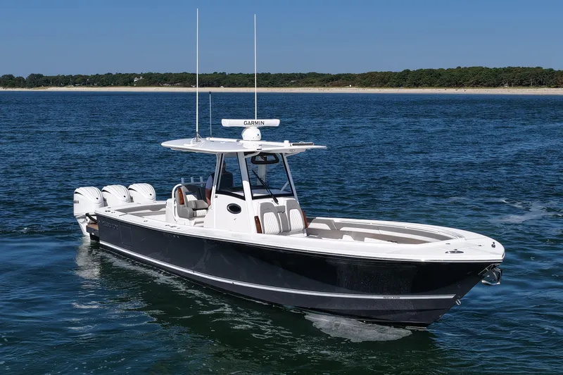 Slide: The Image of 2024 Regulator 34 boat cruising on open water with clear blue sky. - 11