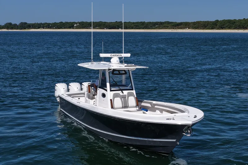 Slide: The Image of 2024 Regulator 34 boat on open water, featuring sleek design and advanced Garmin technology. - 12