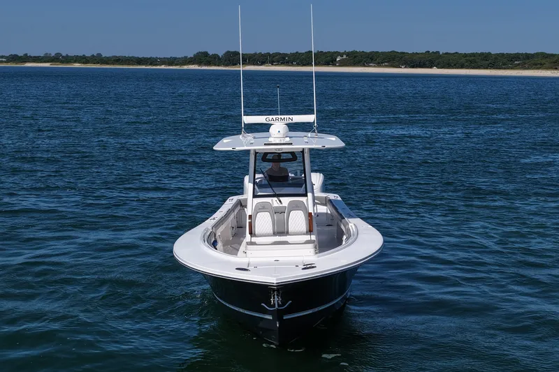 Slide: The Image of 2024 Regulator 34 boat on calm water, featuring Garmin equipment. - 13