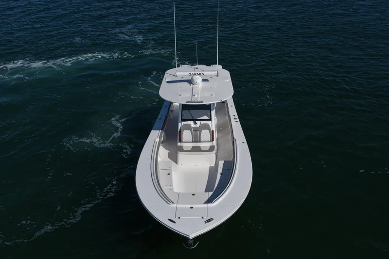 Slide: The Image of 2024 Regulator 34 boat on open water, aerial view showcasing sleek design. - 15