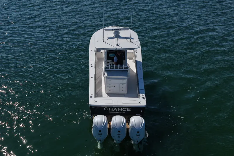 Slide: The Image of 2024 Regulator 34 boat with triple engines cruising on open water. - 18