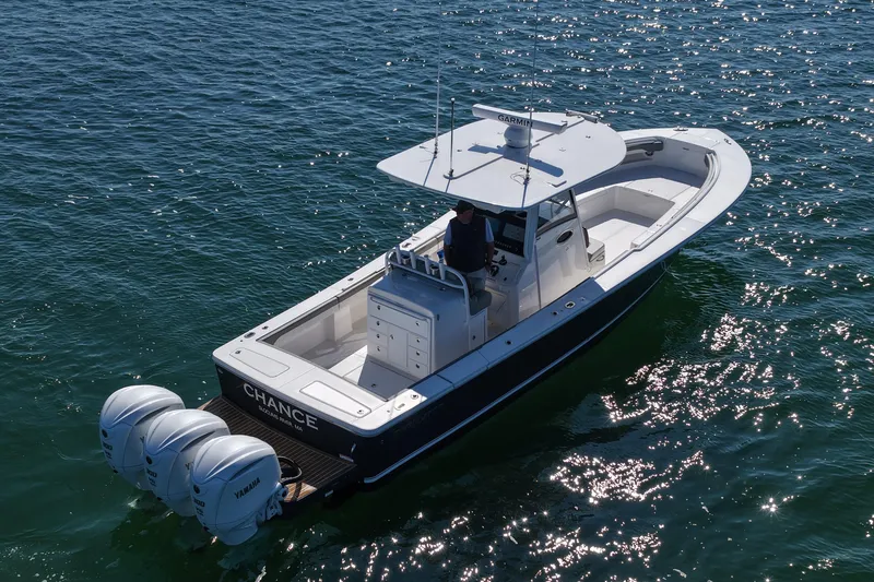 Slide: The Image of 2024 Regulator 34 boat with triple Yamaha engines on open water. - 19