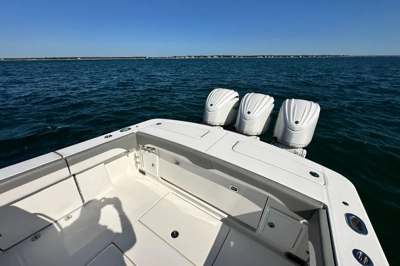 Slide: The Image of 2024 Regulator 34 boat with triple engines on open water. - 26