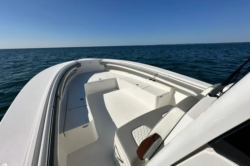 Slide: The Image of 2024 Regulator 34 boat on open water, showcasing spacious deck and seating. - 28