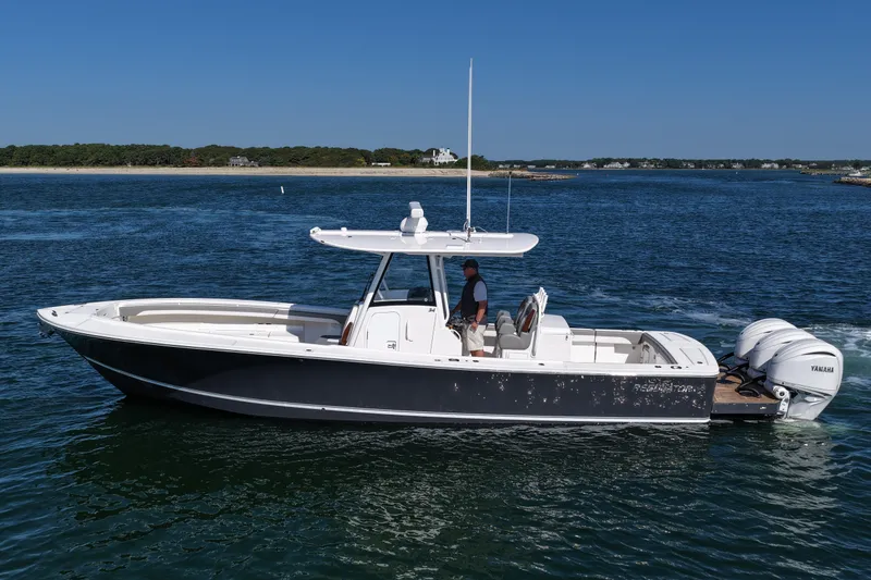 Slide: The Image of 2024 Regulator 34 boat cruising on open water with clear blue sky. - 3