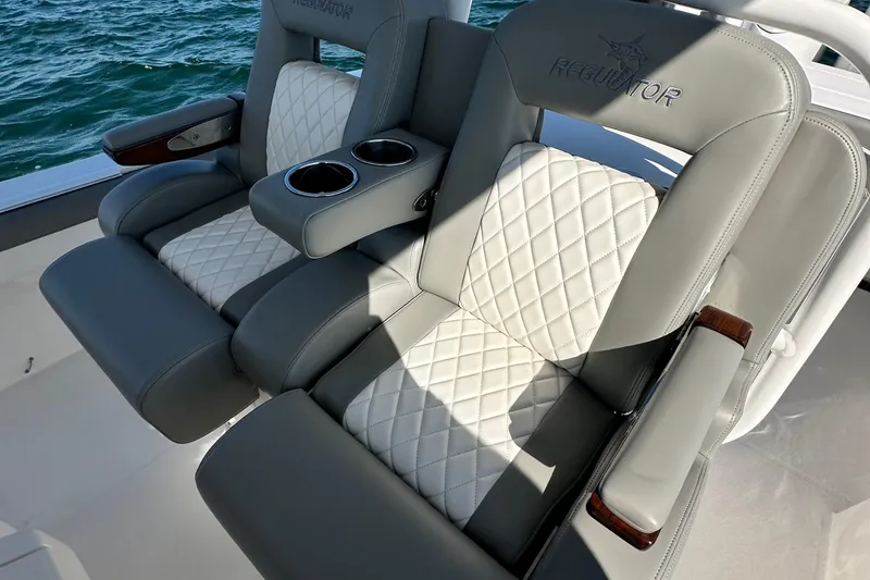 Slide: The Image of Luxurious seating on 2024 Regulator 34 boat with quilted upholstery and cup holders. - 38