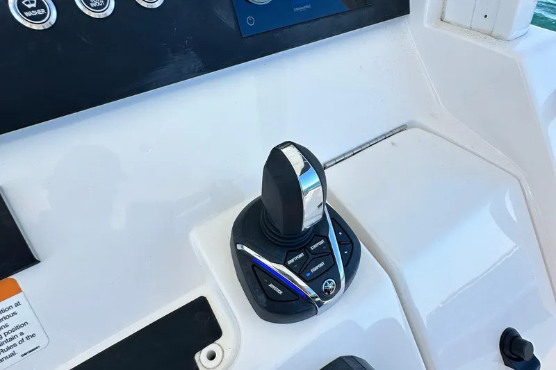 Slide: The Image of 2024 Regulator 34 boat control panel with joystick and buttons. - 43