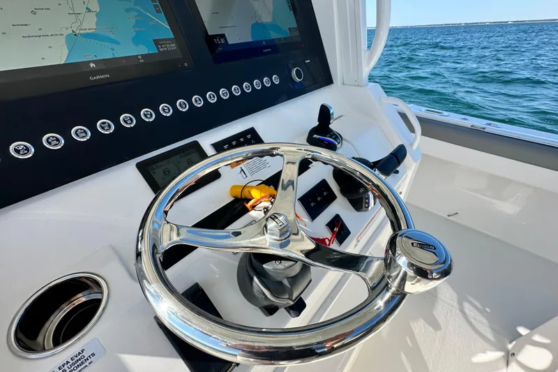 Slide: The Image of 2024 Regulator 34 boat helm with modern controls and navigation screens. - 45