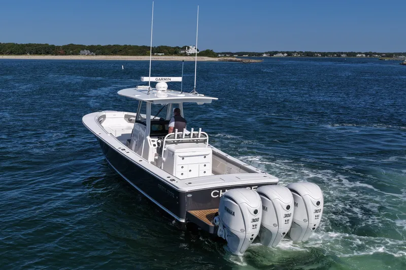 Slide: The Image of 2024 Regulator 34 boat with triple Yamaha engines cruising on open water. - 5