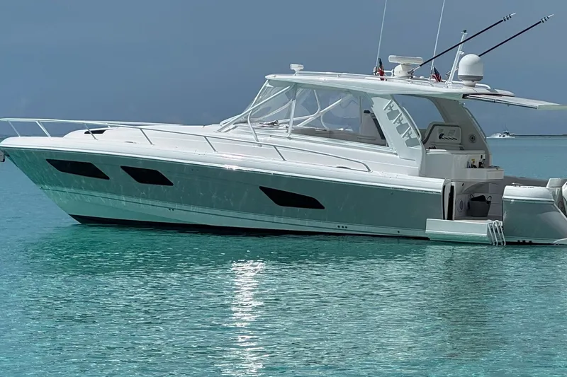 Slide: The Image of 2022 Intrepid 477 Evolution yacht on clear turquoise water. - 1