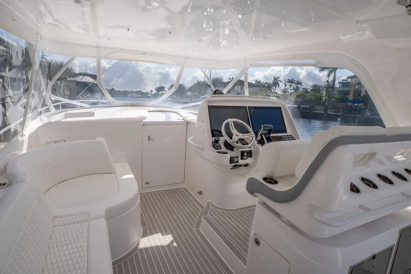 Slide: The Image of Luxurious 2022 Intrepid 477 Evolution yacht interior with modern helm and seating. - 12