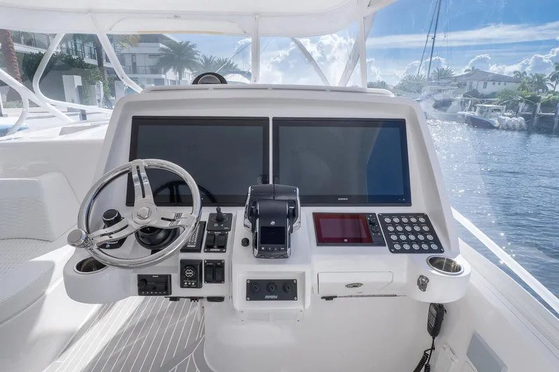 Slide: The Image of 2022 Intrepid 477 Evolution helm with dual screens and modern controls. - 13