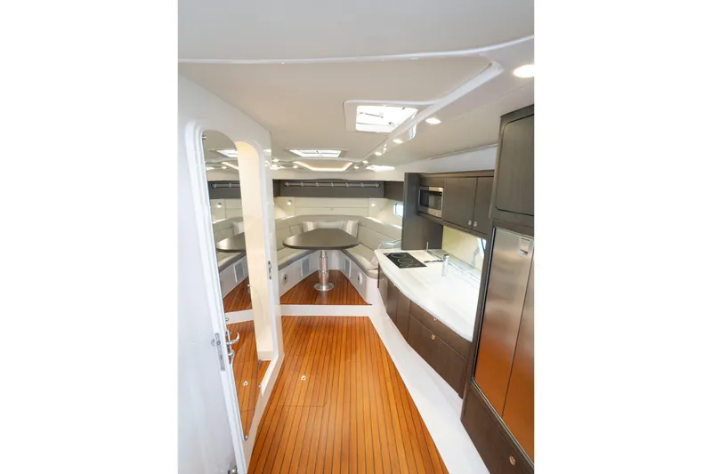 Slide: The Image of Luxurious interior of 2022 Intrepid 477 Evolution yacht with modern kitchen and seating area. - 14