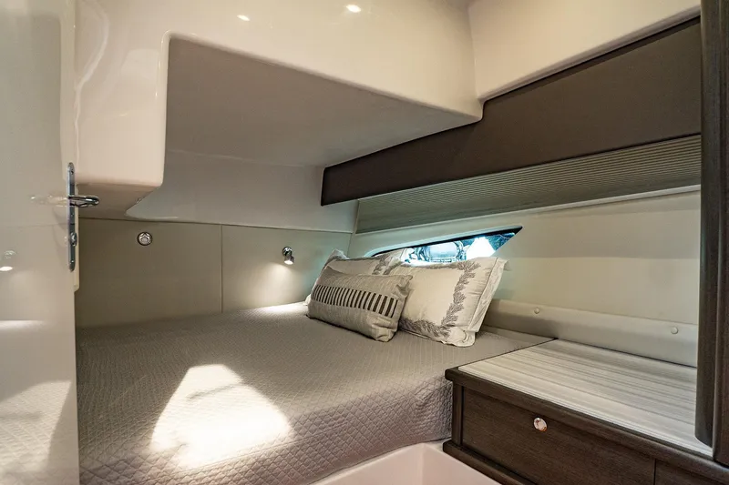 Slide: The Image of Luxurious cabin interior of 2022 Intrepid 477 Evolution yacht with cozy bedding. - 17