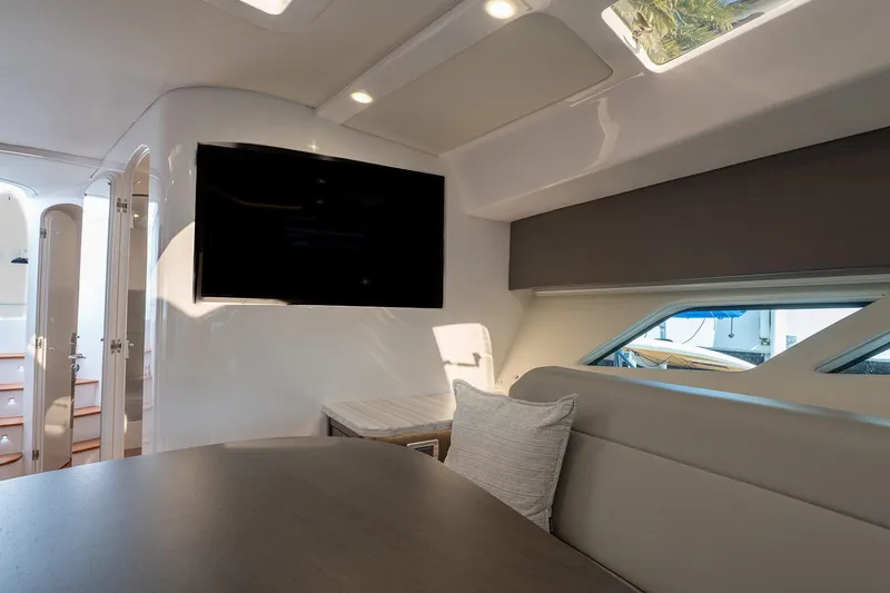 Slide: The Image of Luxurious interior of 2022 Intrepid 477 Evolution yacht with modern seating and large TV. - 18